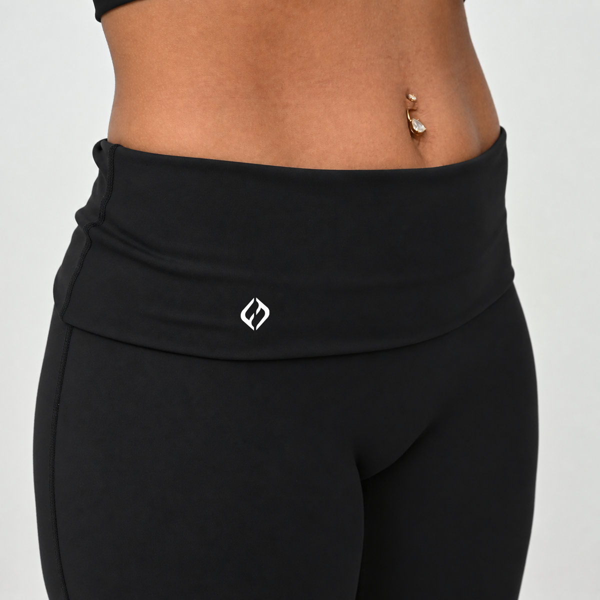 Close-up of HYBRYD Gracie black wide leg leggings fold over waistband and seam detail