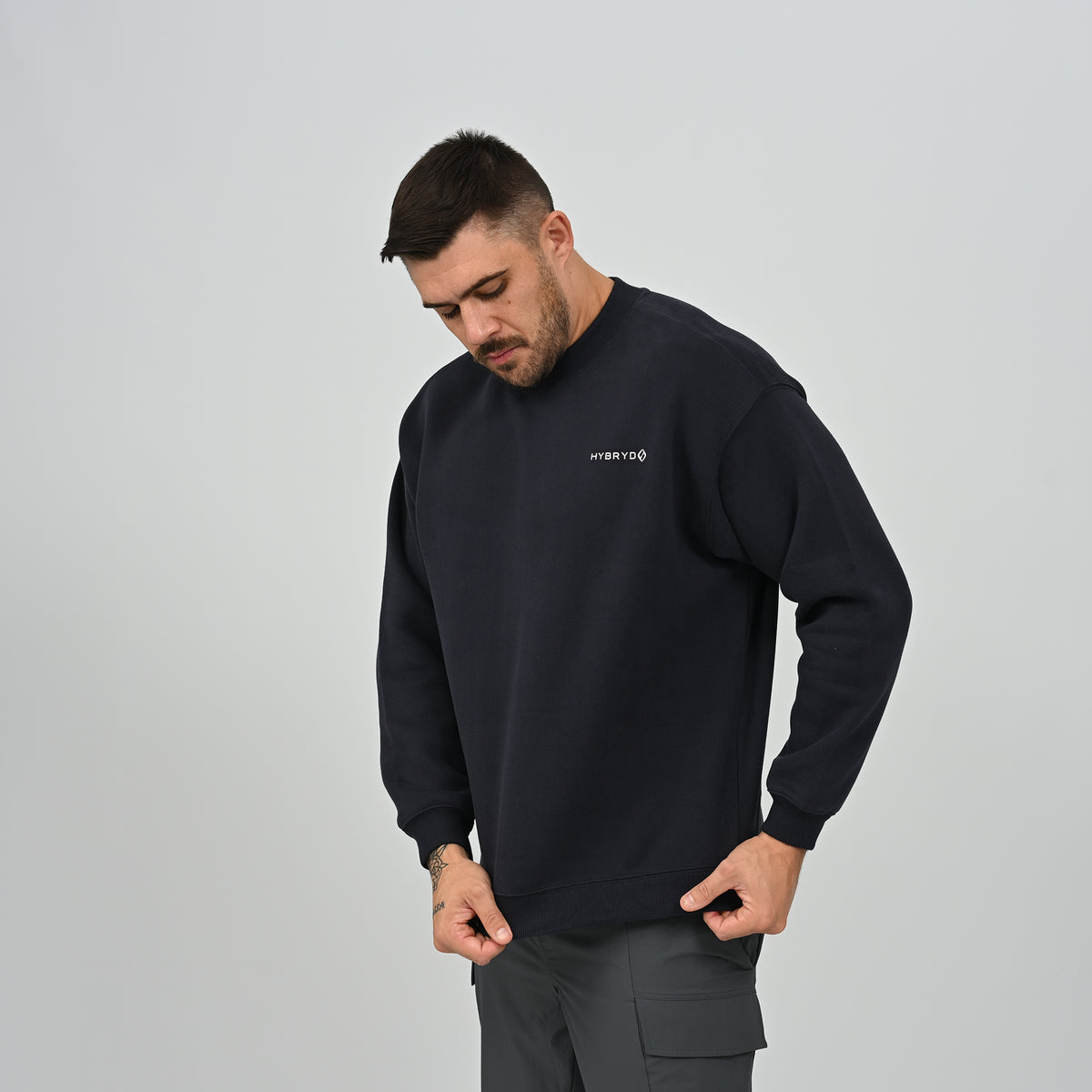 Side angle view of the men's Jasper crew neck sweatshirt in navy showing relaxed drop shoulder fit.