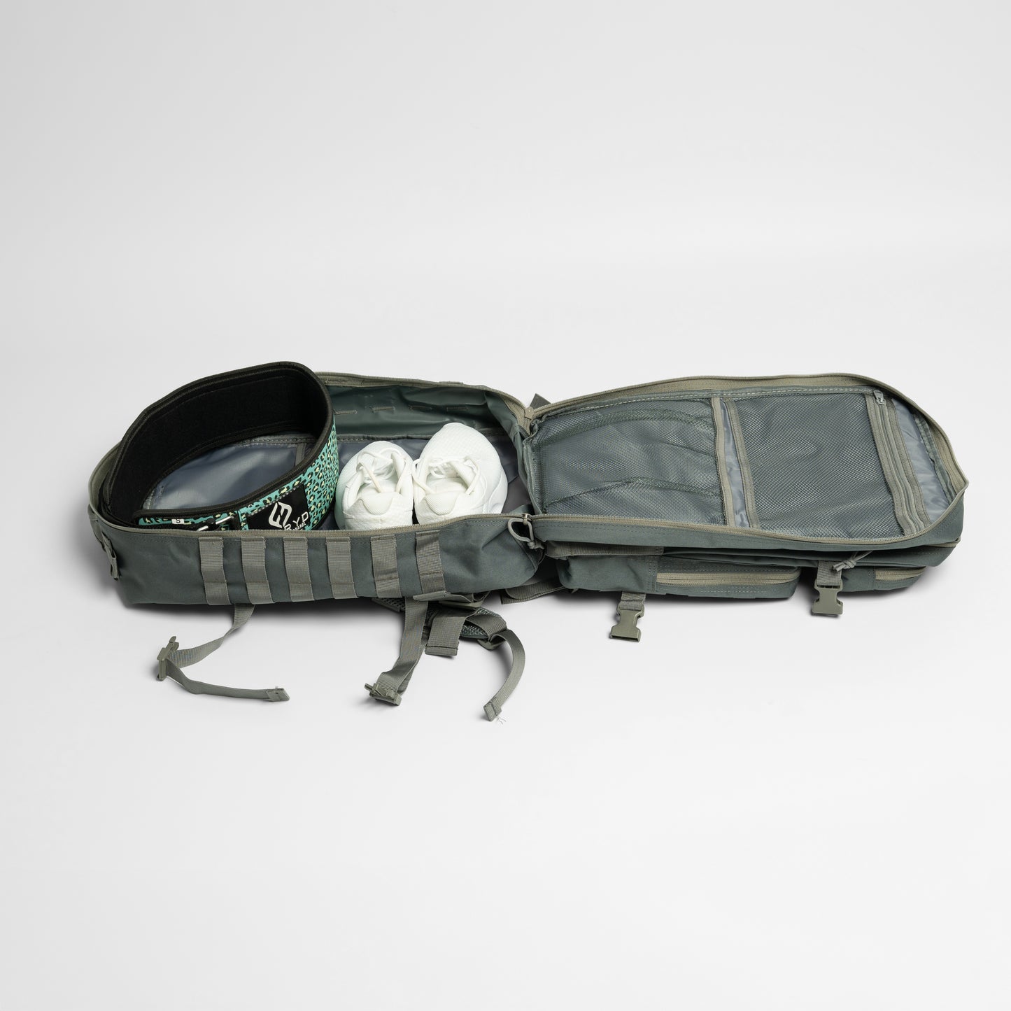 Open gray backpack with shoes inside on a light gray background