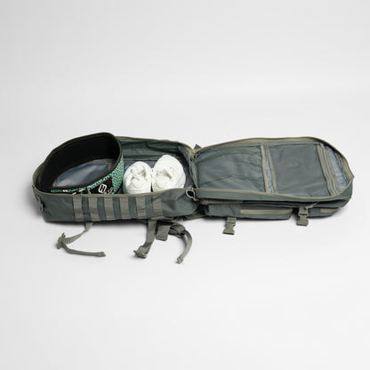 Open gray backpack with shoes inside on a light gray background