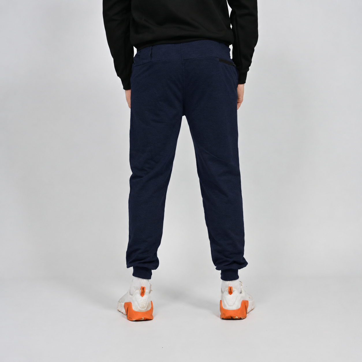 A navy slim fit jogger by Hybryd. Worn by a crossfit athlete with white Nike trainers. 