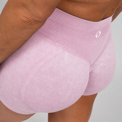 Acid wash pink booty shorts with glute shaping sinch from Hybryd, worn by a crossfit athlete.