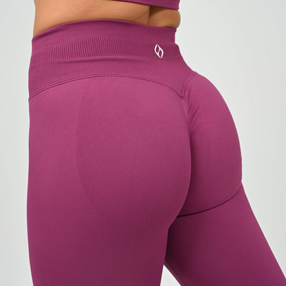 Hyrox gym girl wearing purple cinch bum leggings with contouring. Part of a matching set.  From gymwear brand Hybryd.