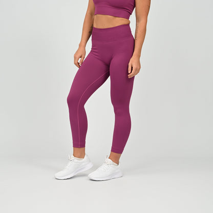 Hyrox gym girl wearing purple cinch bum leggings with contouring. Part of a matching set.  From gymwear brand Hybryd.