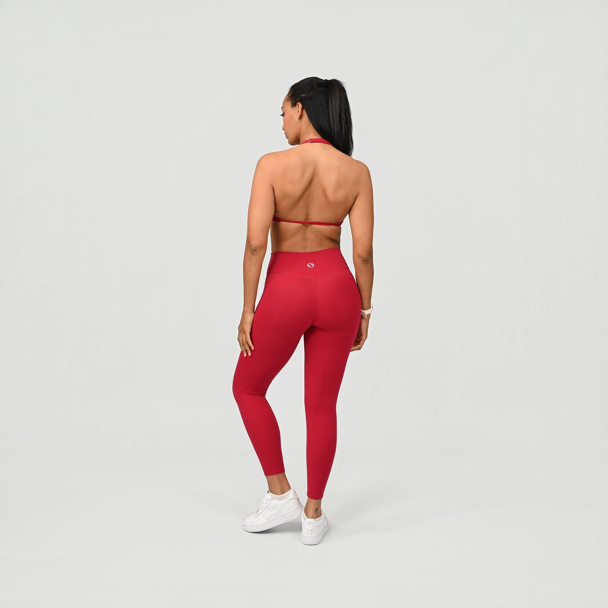 Person wearing red compression leggings on a light gray background