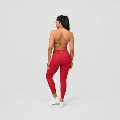 Person wearing red compression leggings on a light gray background