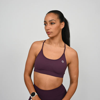 Woman wearing a purple Hybryd sports bra and matching leggings
