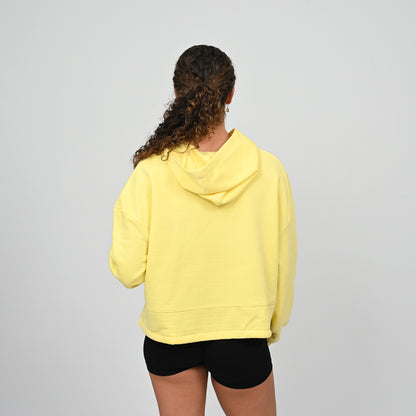 Woman wearing cropped oversized hoodie. Dropped shoulders, oversized relaxed fit with a drawstring fastening from Hybryd gymwear.