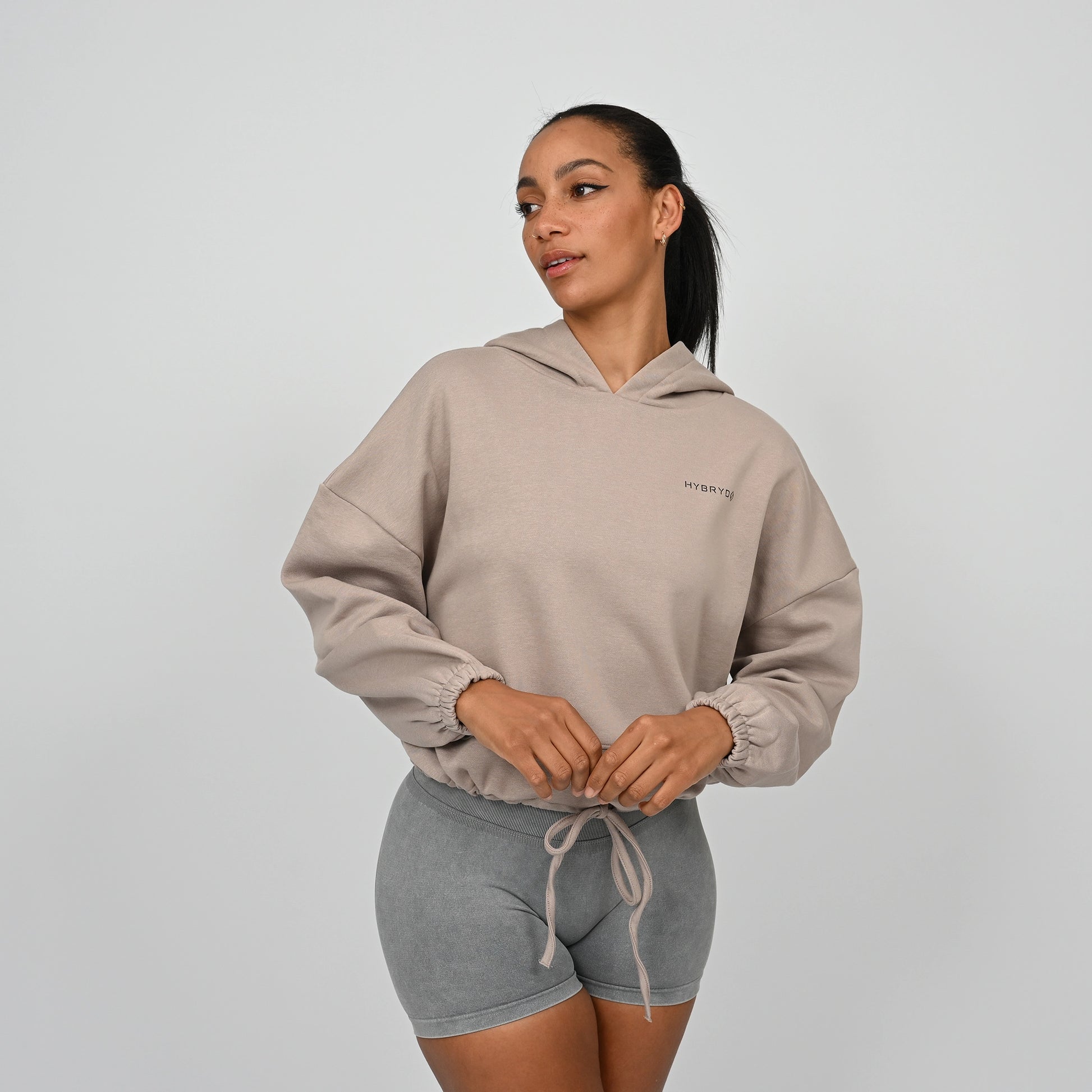 An oversized hoodie from Hybryd worn with grey bootie shorts