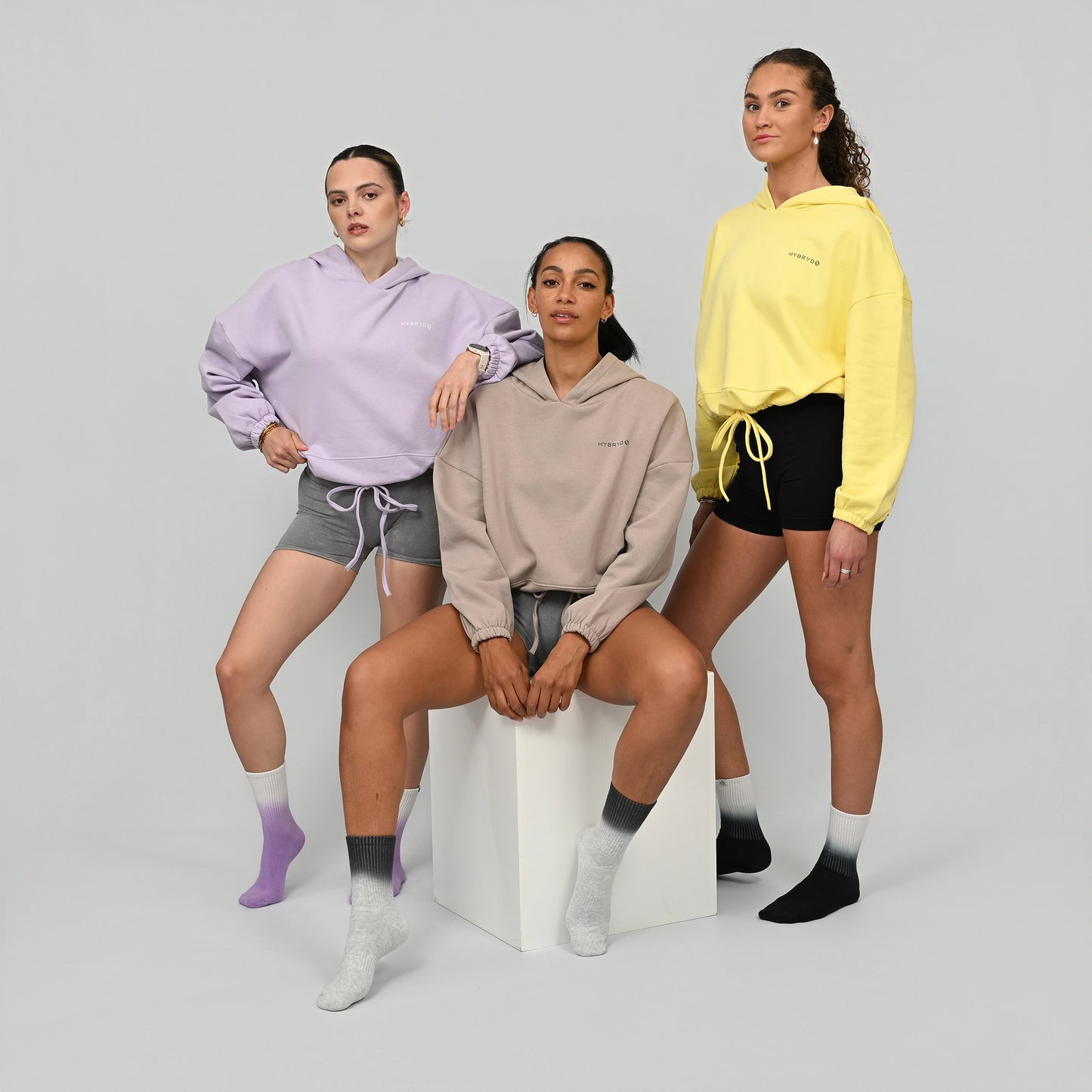 Three women wearing cropper hoodies and bootie shorts from actiewear brand Hybryd