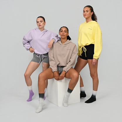 Three women wearing cropper hoodies and bootie shorts from actiewear brand Hybryd