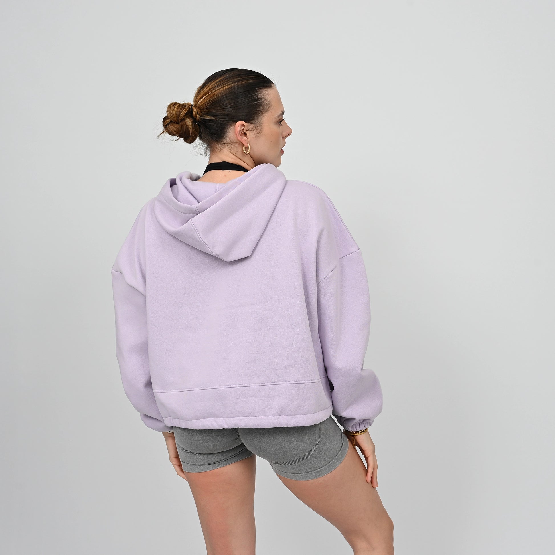 Woman wearing an oversized hoody from the activewear brand Hybryd