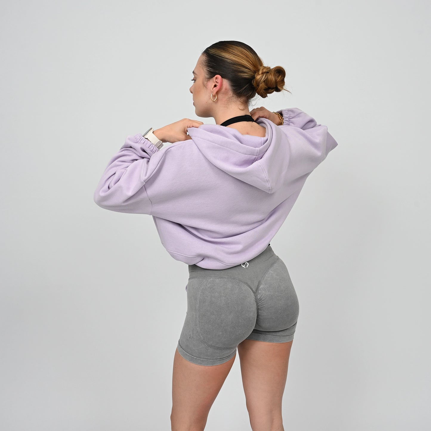 An oversized Hybryd hoodie in lilac. Grey scrunch bum booty shorts. 