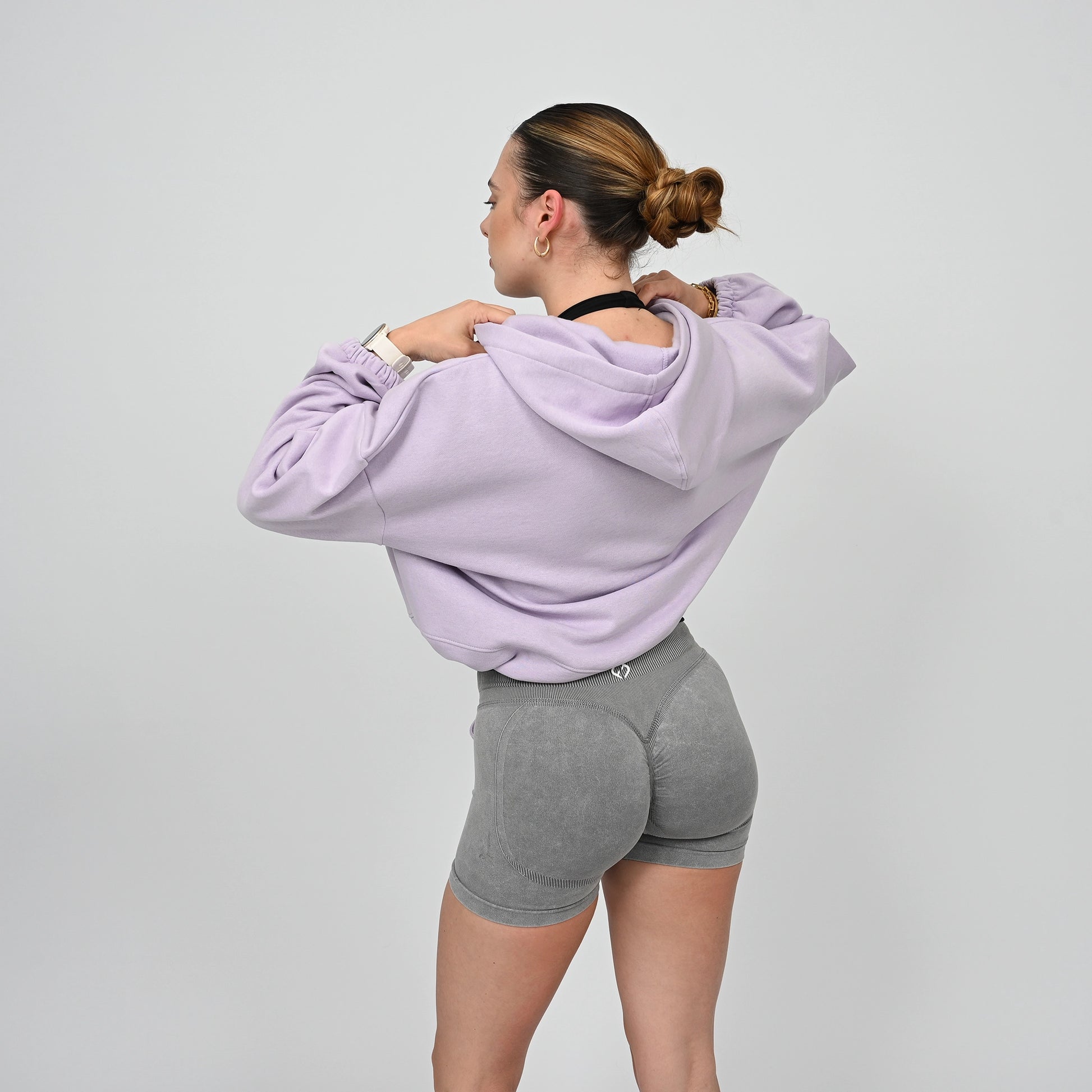 An oversized Hybryd hoodie in lilac. Grey scrunch bum booty shorts. 