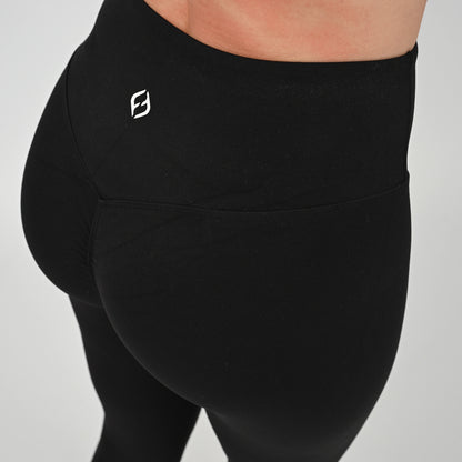 Black contouring gym leggings with a bum scrunch and logo on a gray background