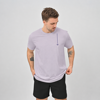 A Hyrox athlete wearing  cotton lilac T-shirt and black gym shorts from crossfit brand Hybryd