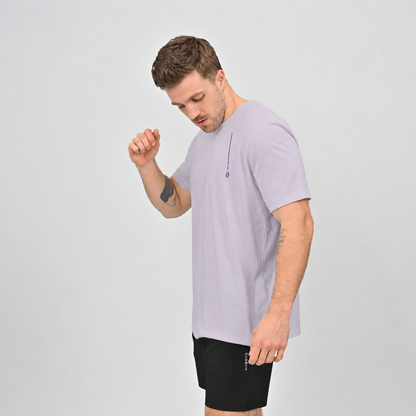 A Hyrox athlete wearing  cotton lilac T-shirt and black gym shorts from crossfit brand Hybryd