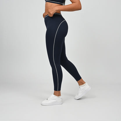 Hybrid yoga athlete wearing a navy crossfit gym outfit with white stripes on a gray background from Hybryd