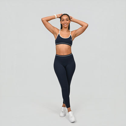Hybrid yoga athlete wearing a navy crossfit gym matching set with white stripes on a gray background from Hybryd