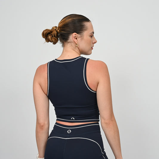 Hyrox model wearing a navy athletic gym top with white contrast piping.