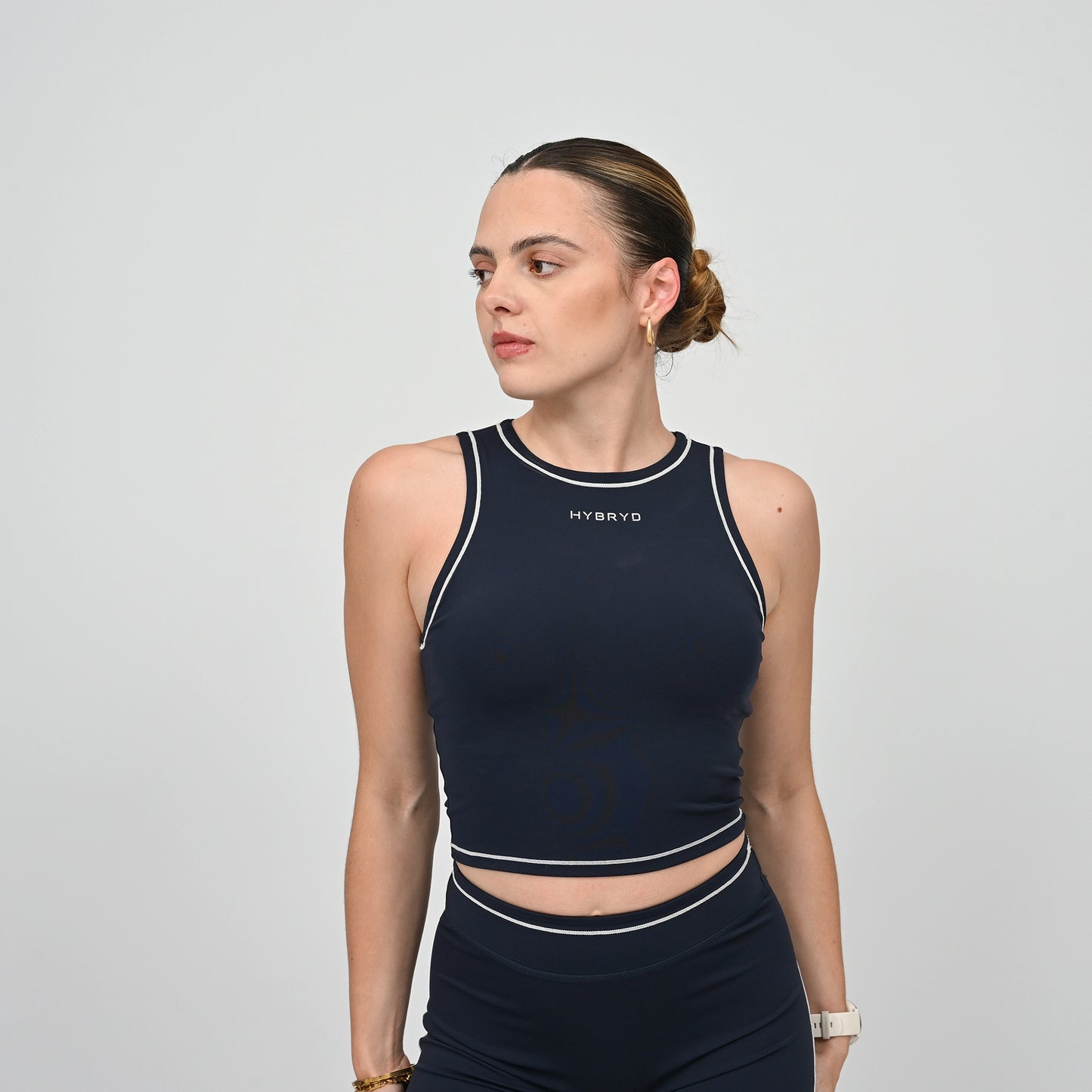 Hyrox model wearing a navy athletic gym top with white contrast piping.