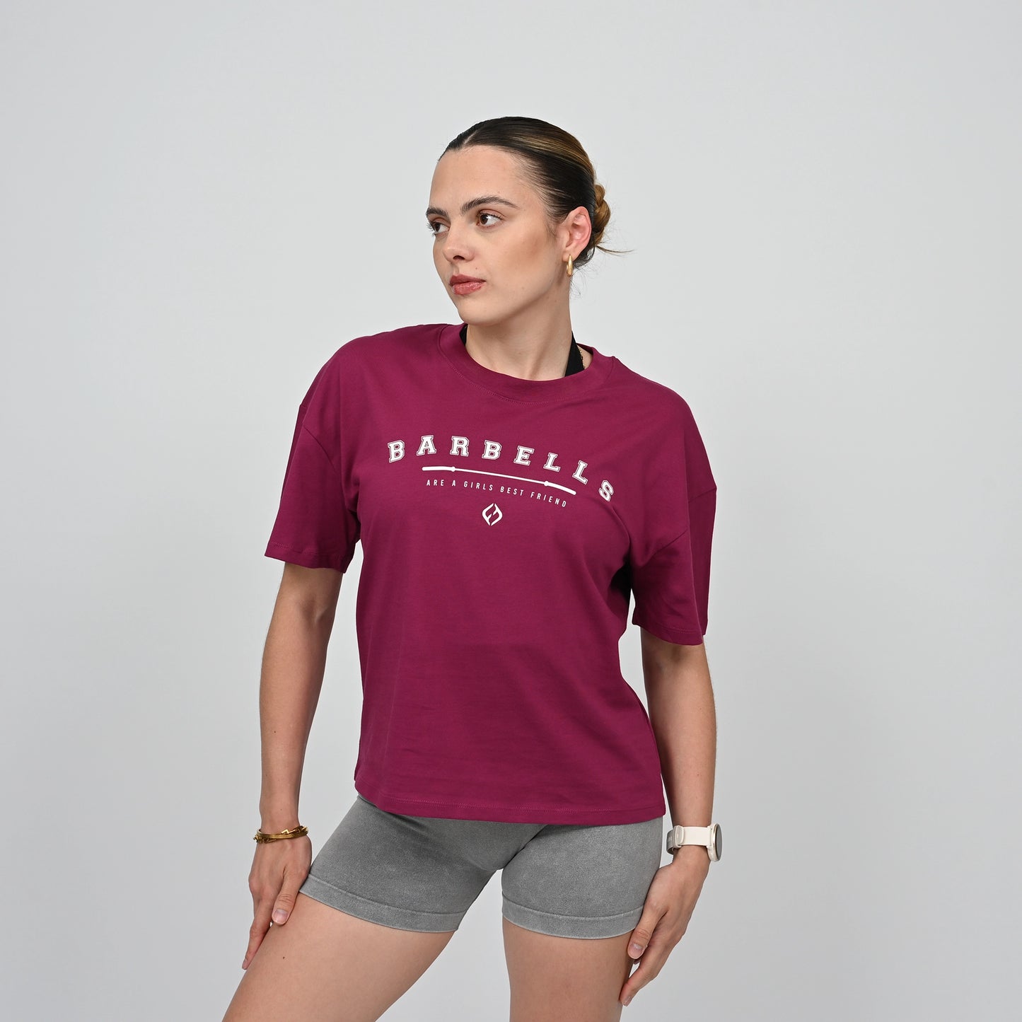 Woman wearing a Hybryd maroon t-shirt with 'Barbells' logo on it