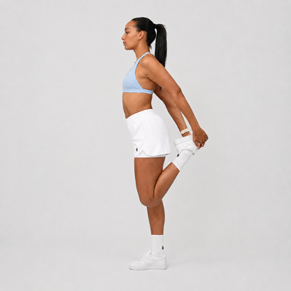A pair of white run shorts with an inner short and pockets. An elastictic waistband. Made for running from activewear brand Hybryd. Worn with a sky blue sports bra. 