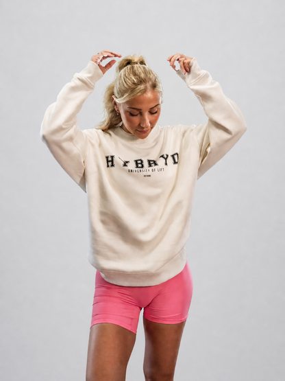 Woman wearing an oversized crew with a varsity style print from gymwear brand Hybryd.