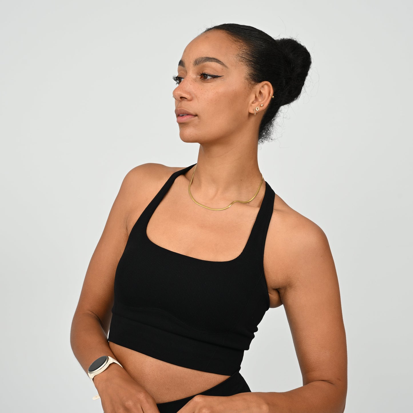 CrossFit athlete wearing a black square neck, muscle back sports bra with matching cinch bum bootie shorts from the gymwear brand Hybryd.