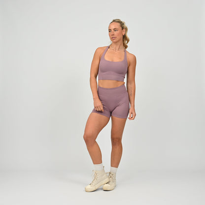 CrossFit athlete wearing a mauve square neck, muscle back sports bra with matching cinch bum bootie shorts from the gymwear brand Hybryd.