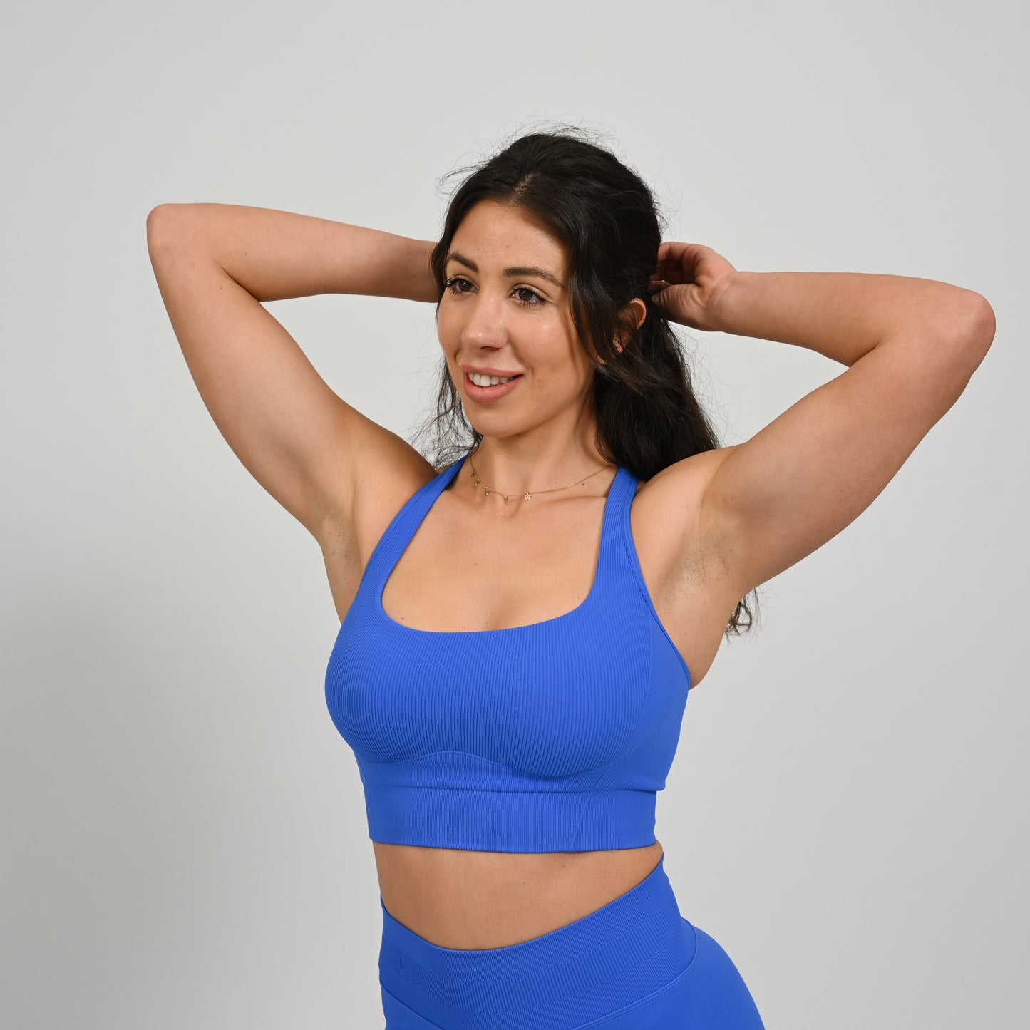 CrossFit athlete wearing a Royal Blue square neck, muscle back sports bra with matching cinch bum bootie shorts from the gymwear brand Hybryd.
