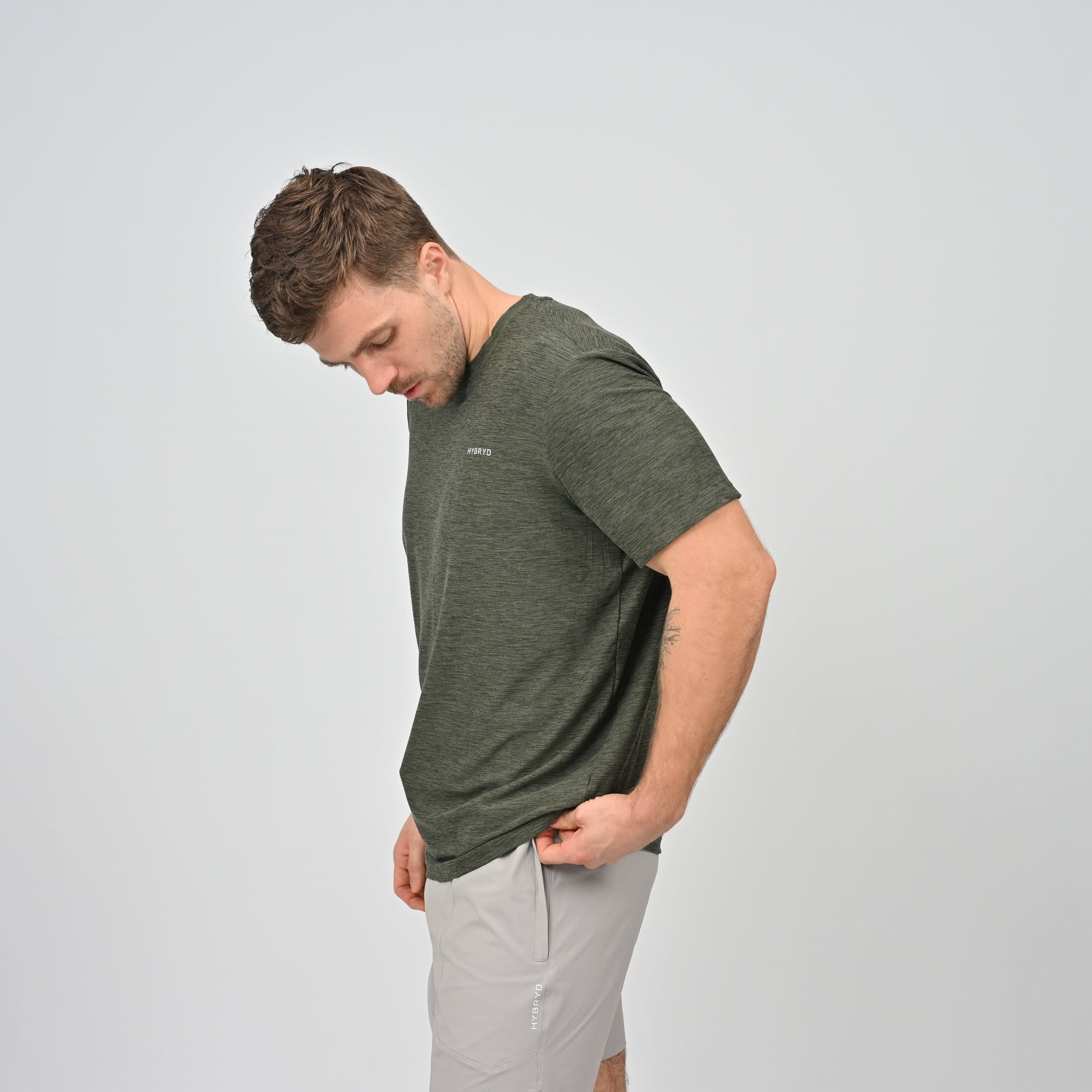 Man wearing a green Hybryd gym t-shirt and sports shorts