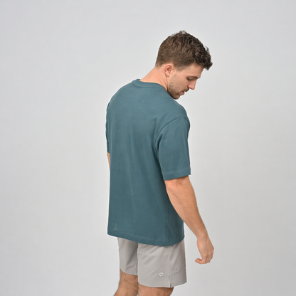 Oversized fir post workout tee from Hybryd activewear, with grey gym shorts.