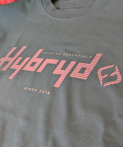close up of logo on a teal Hybryd Tee