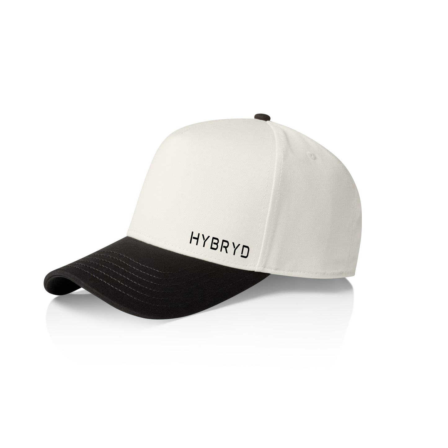 A structured baseball cap with an off-white crown and a black curved brim, featuring the word 'HYBRYD'  in black on the front. The cap is photographed on a clean white background with a soft reflection underneath.