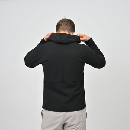 Athlete wearing a black Hybryd hoodie from behind on a light gray background