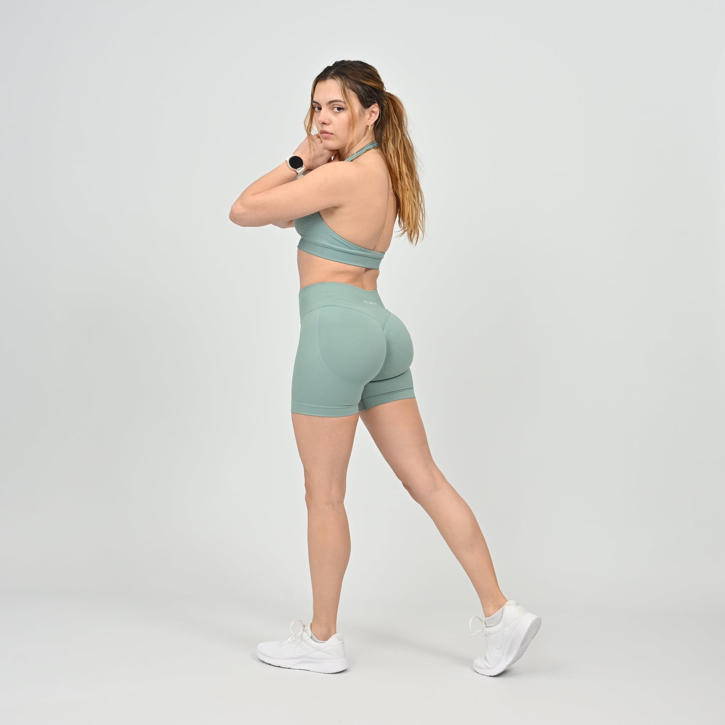 Woman wearing a pale green Hybryd athletic outfit