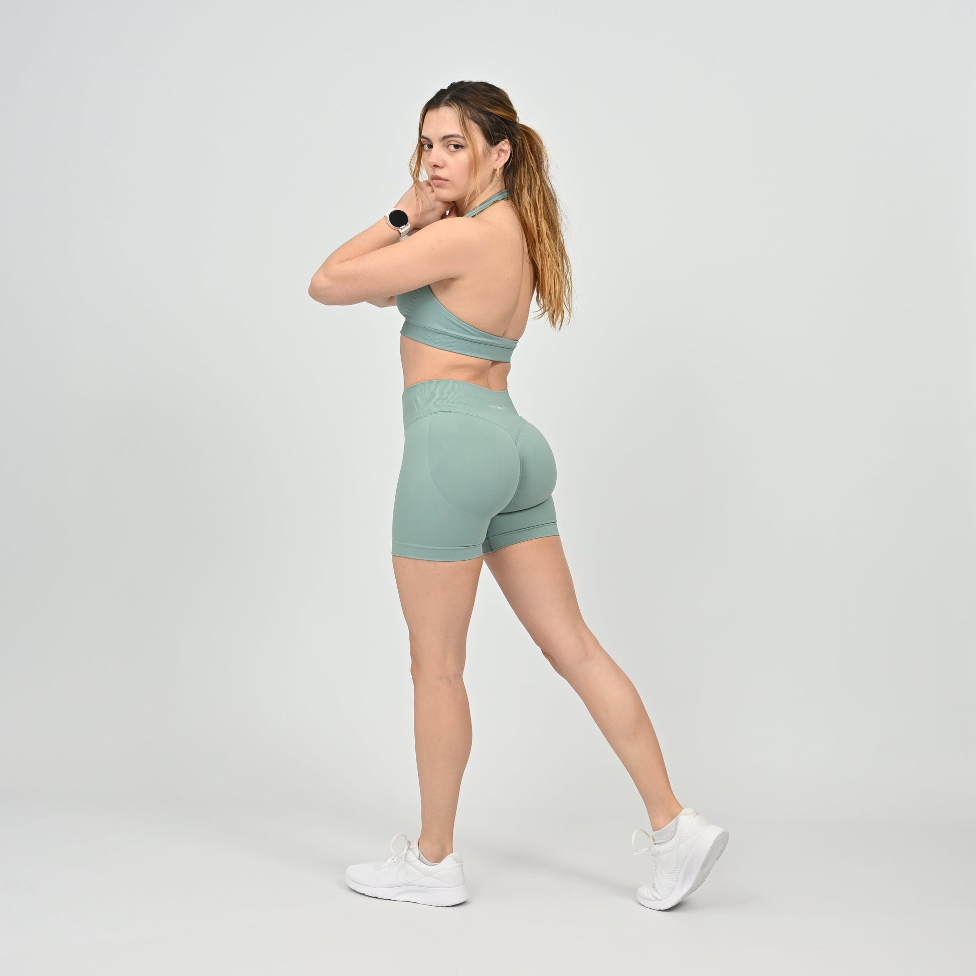 Woman wearing a pale green Hybryd athletic outfit