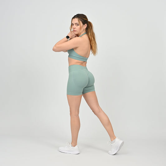 Woman wearing a pale green Hybryd athletic outfit