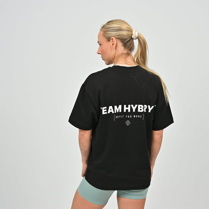 Person wearing a black 'TEAM HYBRYD' t-shirt on a plain background