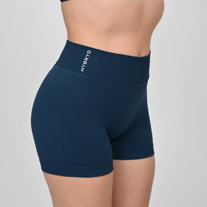 Navy blue athletic shorts with 'HYBRYD' logo and ribbed waistband on a gray background