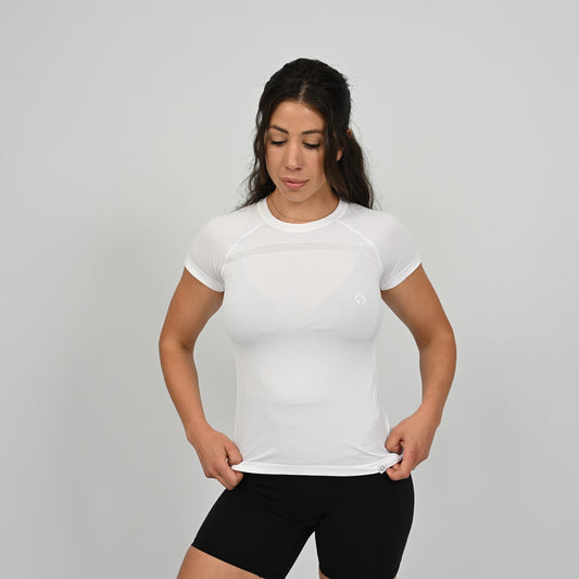 Hybryd athlete wearing a white stretchy t-shirt and black shorts on a gray background