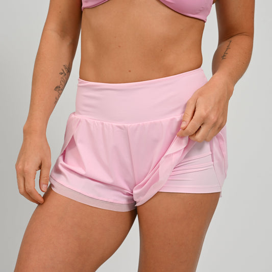 Athlete wearing pink running shorts with an inner cycling short rought to you by Hybryd activewear.