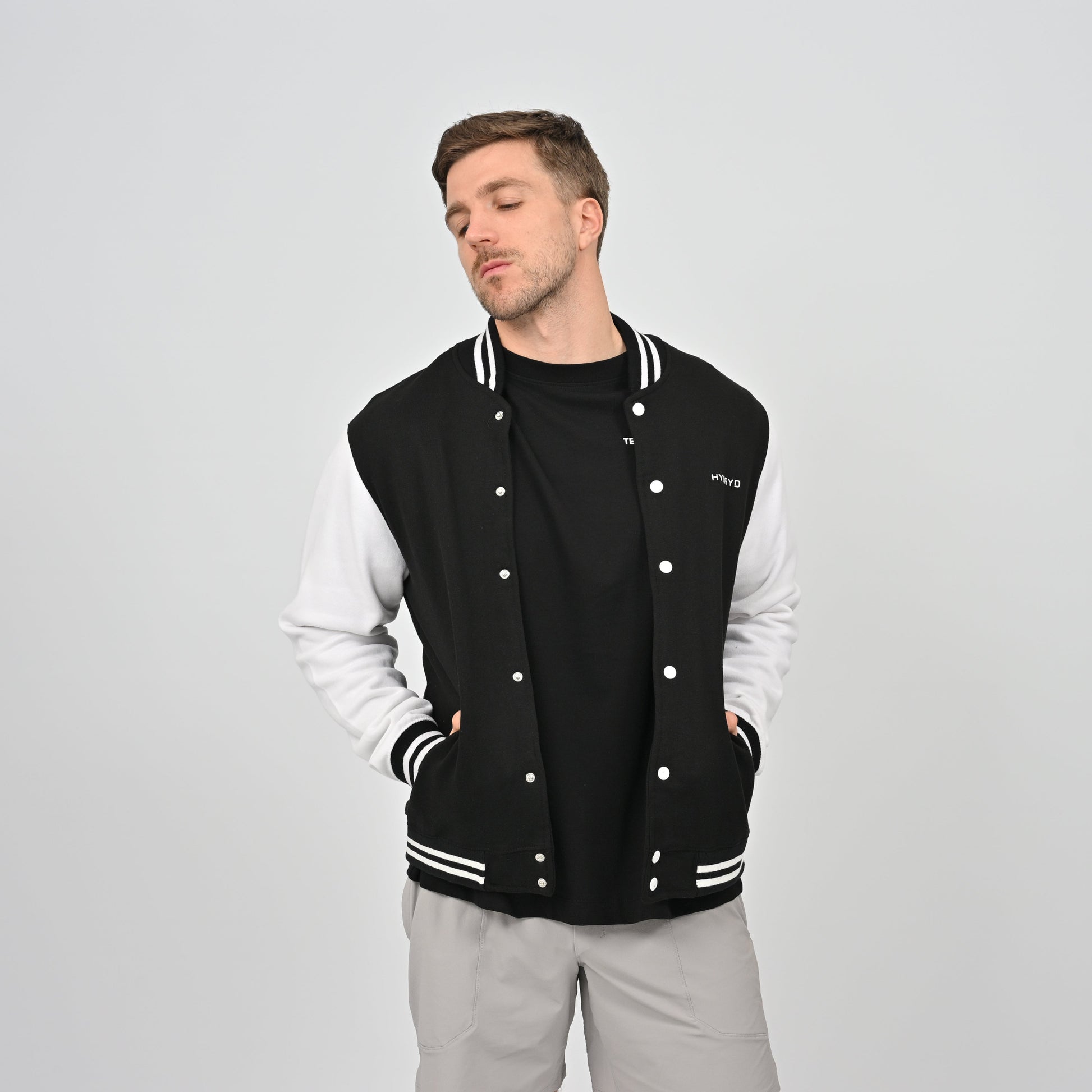 Hybryd college jacket with black and white hems and white sleeves.