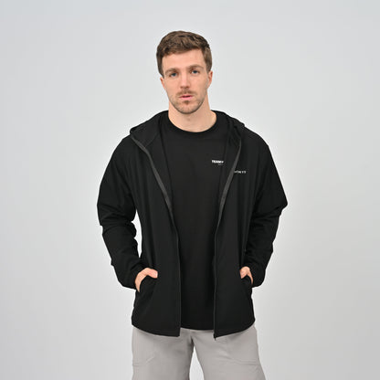 Hybryd guy wearing a black zip jacket with pockets