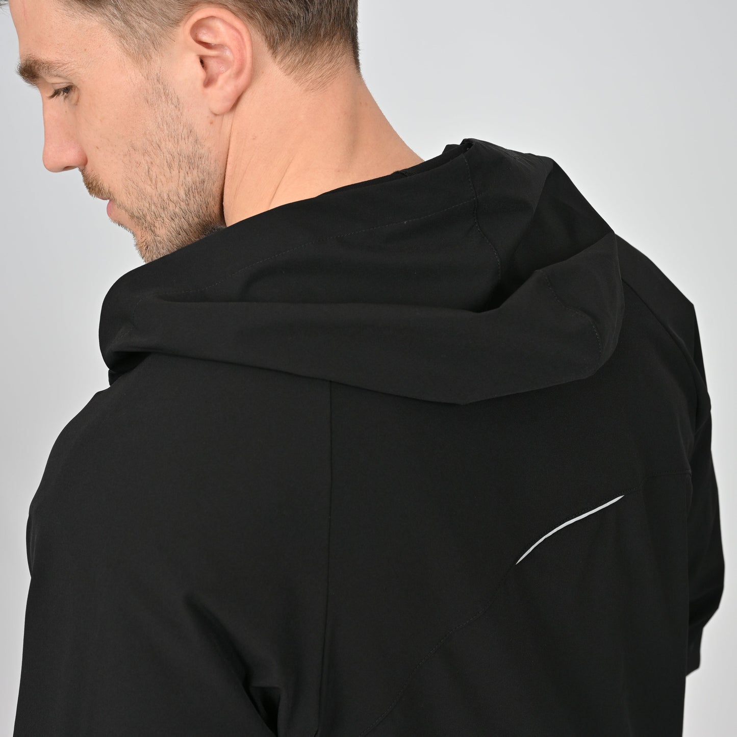 Hybryd workout jacket with reflective strip under hood