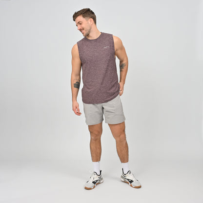 Man wearing a maroon sleeveless shirt and gray gym shorts from Hybryd