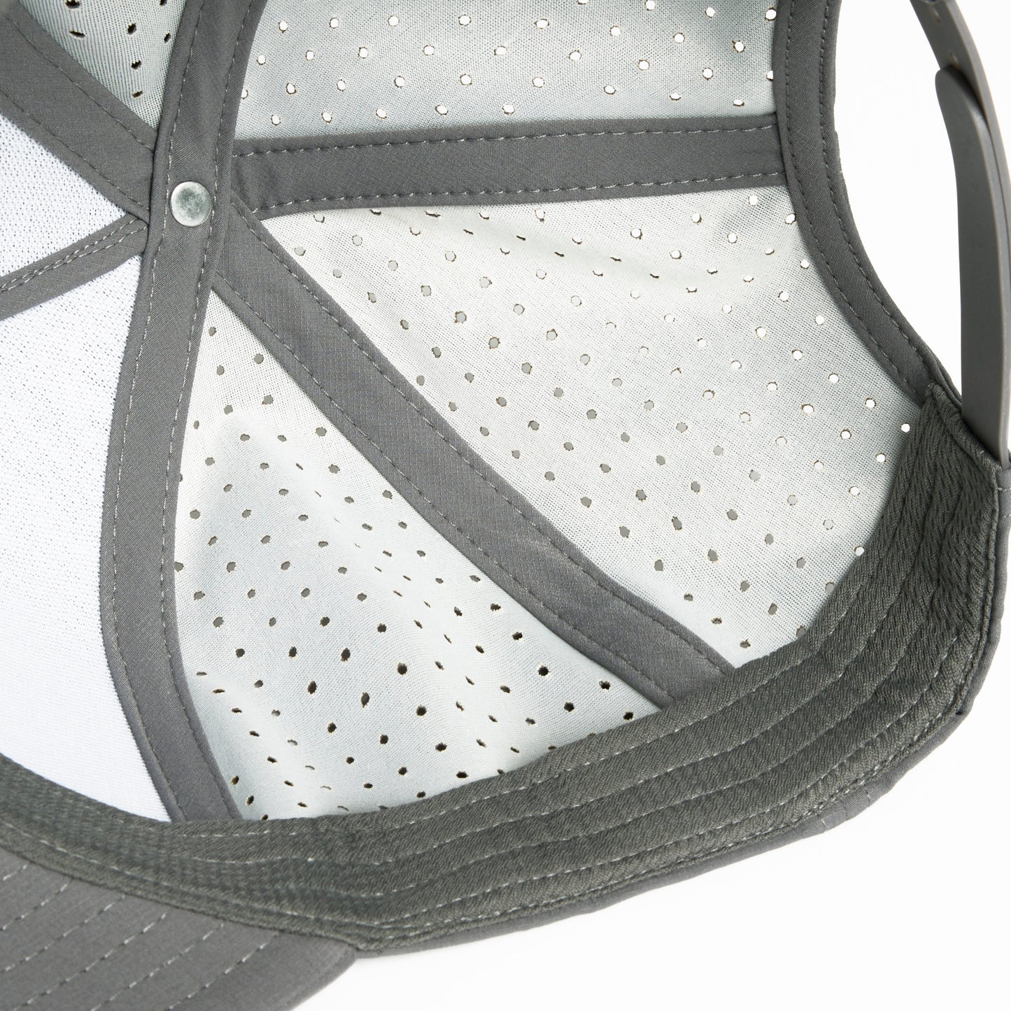 A grey Hybryd athletic baseball cap with perforated back panels and a snapback, white Hybryd logo on the front, showing the inside.