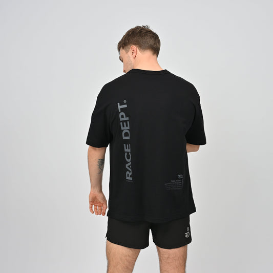 Man wearing a black t-shirt with 'RACE DEPT.' branding on the back,  for running and gym
