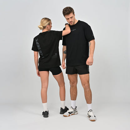 Two people wearing matching black t-shirts and shorts made by Hybryd